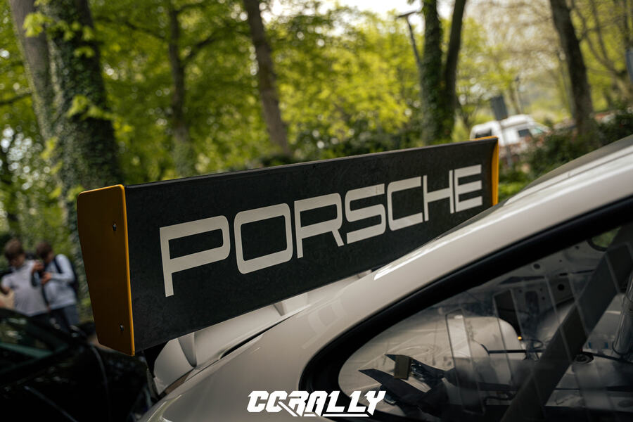 Porsche sign on a white Porsche, with the CCRally logo in view