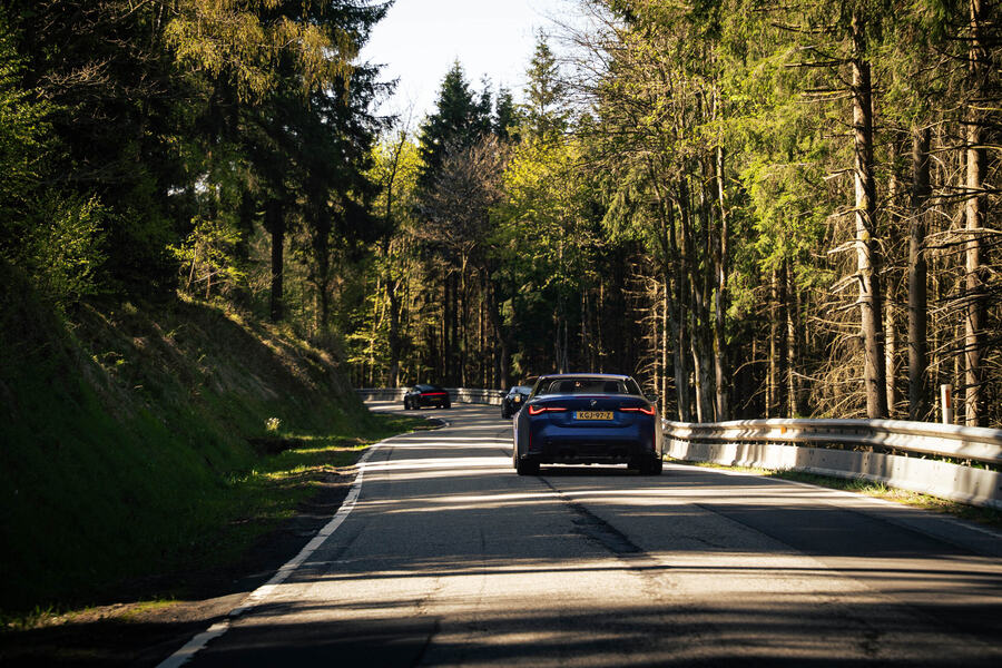 A sports car on a forest road during a road trip