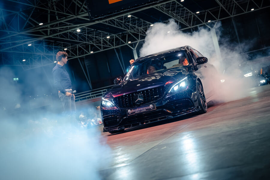 Supercar in a cloud of smoke on the Car Catwalk at a car show