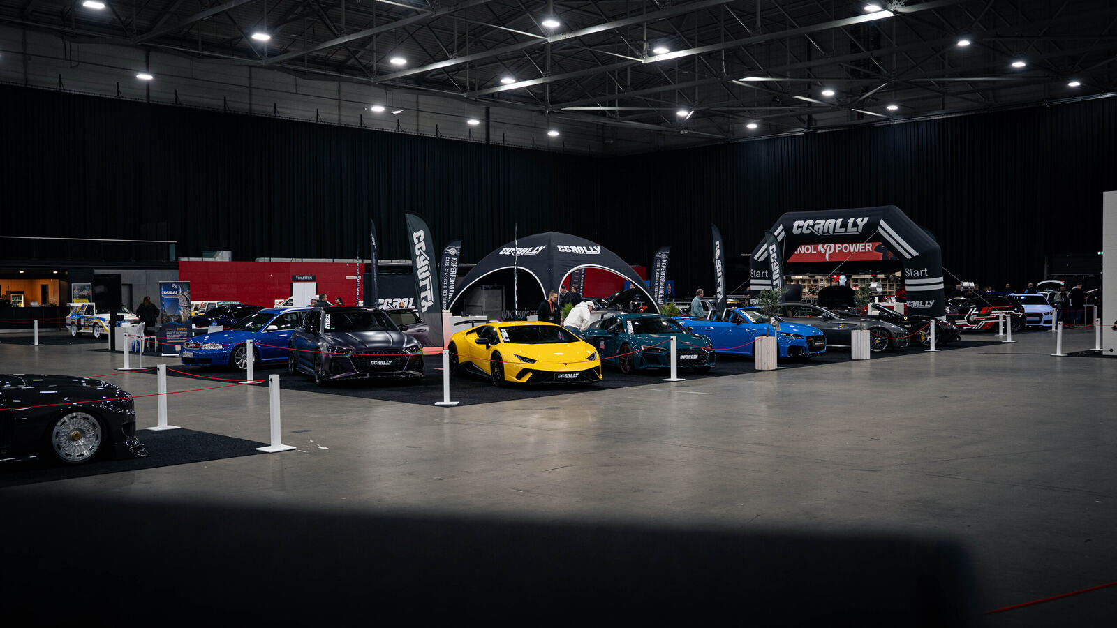 CCRally stand with supercars in a large event hall during a supercar event in the Netherlands