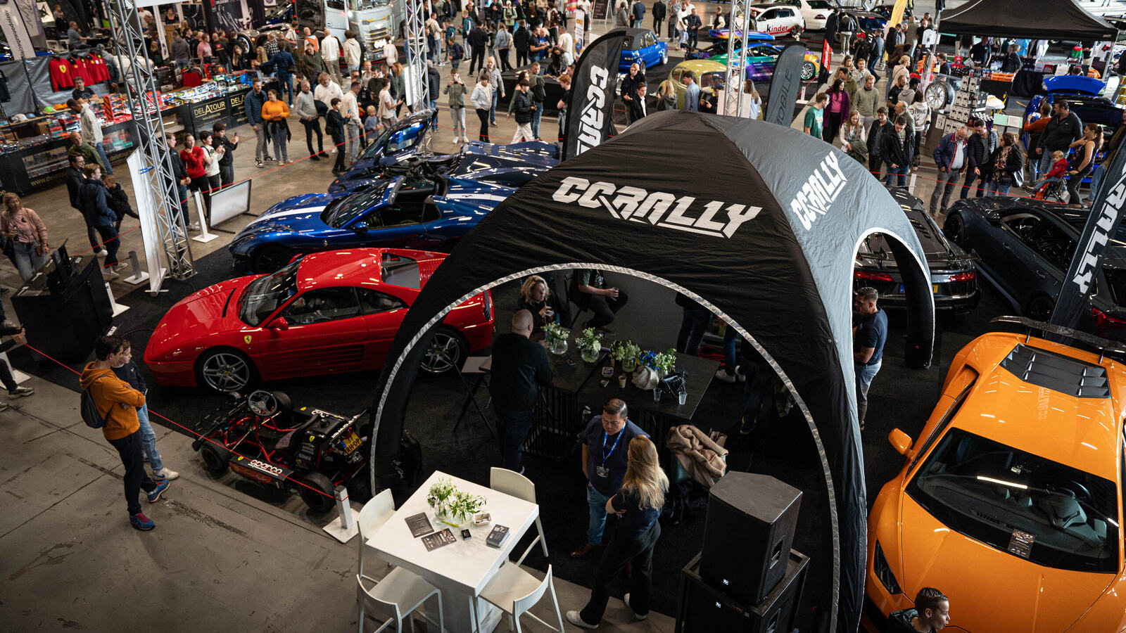 The CCRally stand among the supercars at a car show in the Netherlands, seen from above